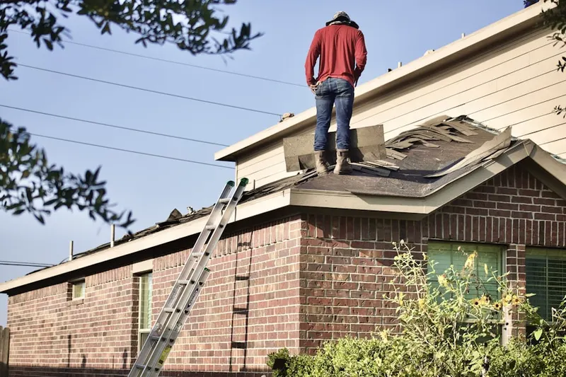 Professional roofer working on a residential roof in Twin Oaks